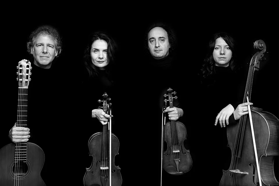 The same row of four musicians in black and white
